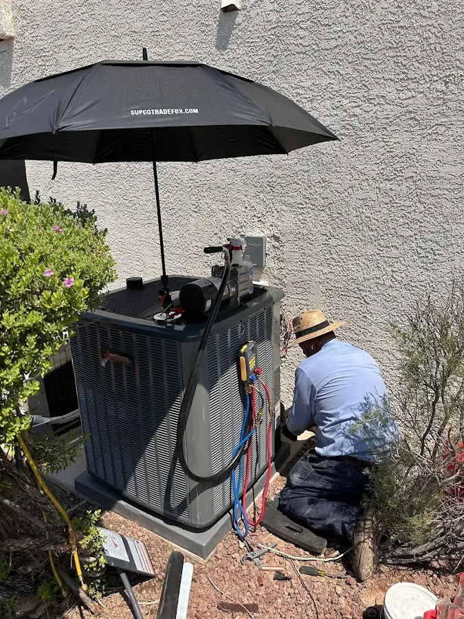HVAC technician performing outdoor AC maintenance in Northfield